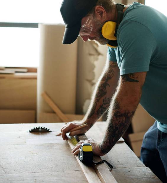 carpenter-using-pencil-measurement-tape-wood